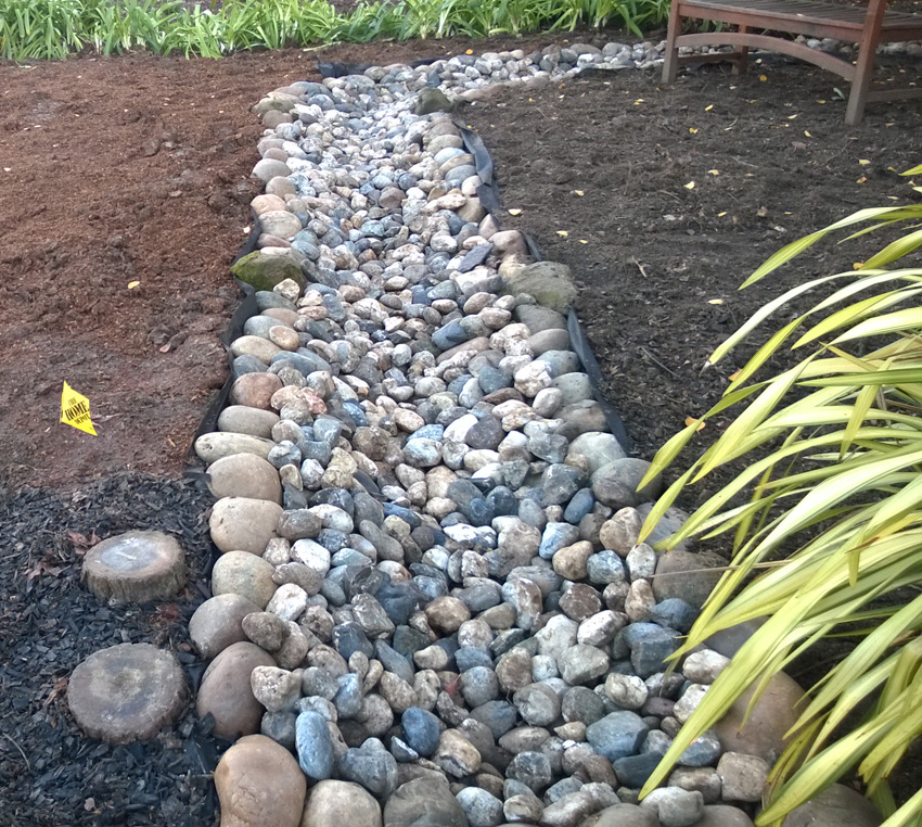 Swale installed with a river-rock top.