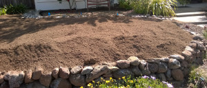 Top soil on yard, a lot higher than the wall. 