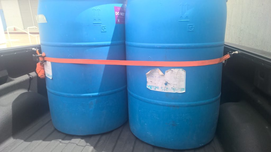 4 - 55 gallon barrels in a pickup truck