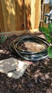 Transfer hose coiled up in front of house.