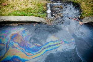 Oil runoff into a storm drain.